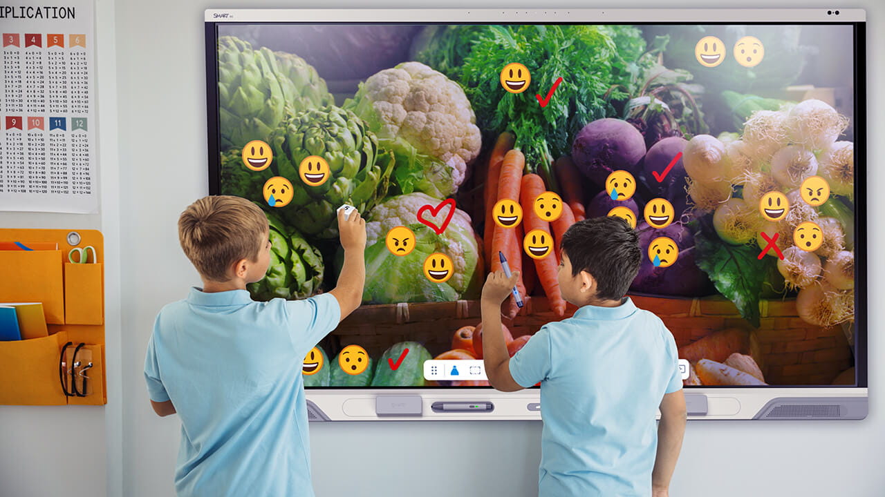 Children collaborating on a SMART Board together.