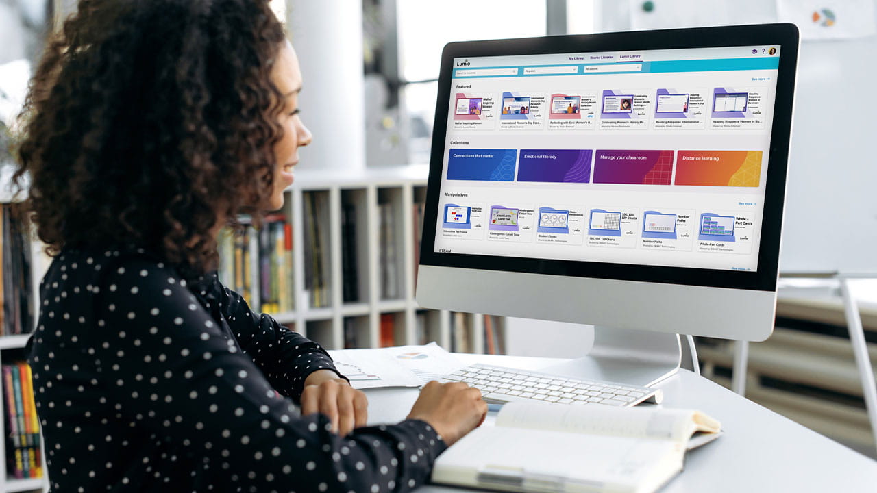 Educator exploring the Lumio digital library on a desktop computer, with collections on Connections that matter, Emotional literacy, and more displayed on screen.