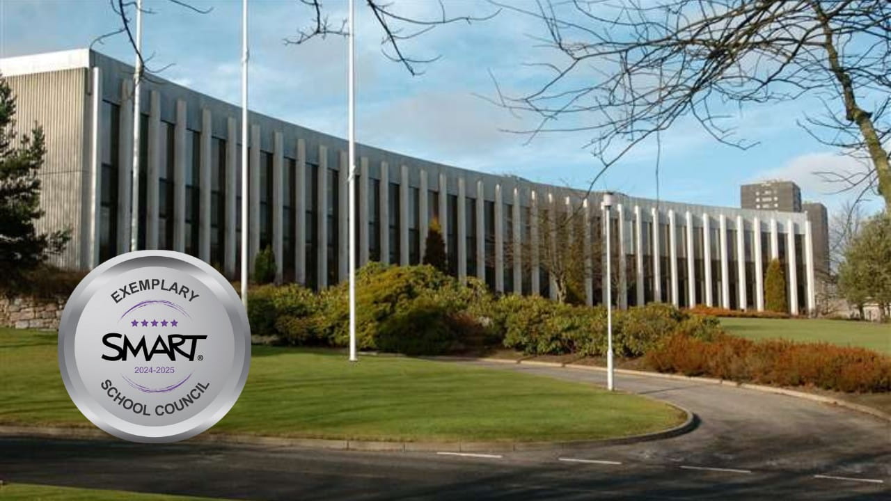 Exterior view of a modern government building in Aberdeenshire with a SMART Exemplary School Council badge for 2024–2025.