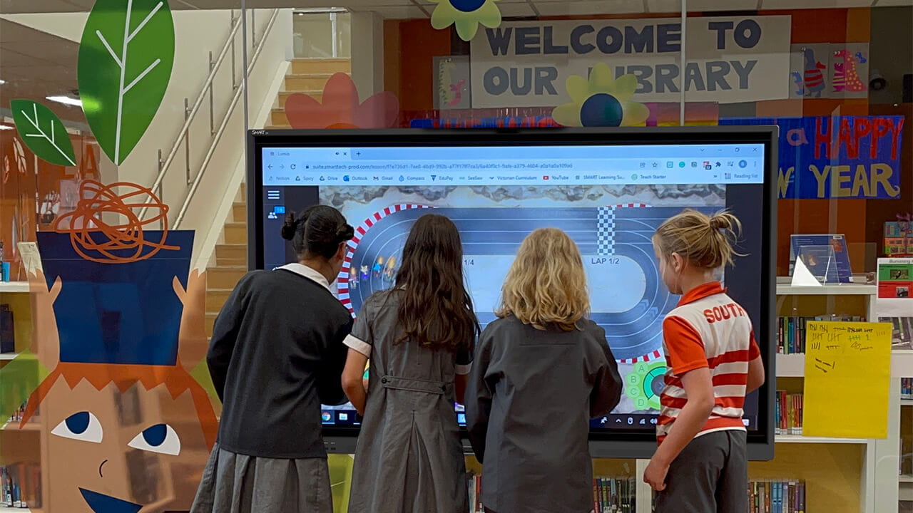 Students collaborating on a SMART Board